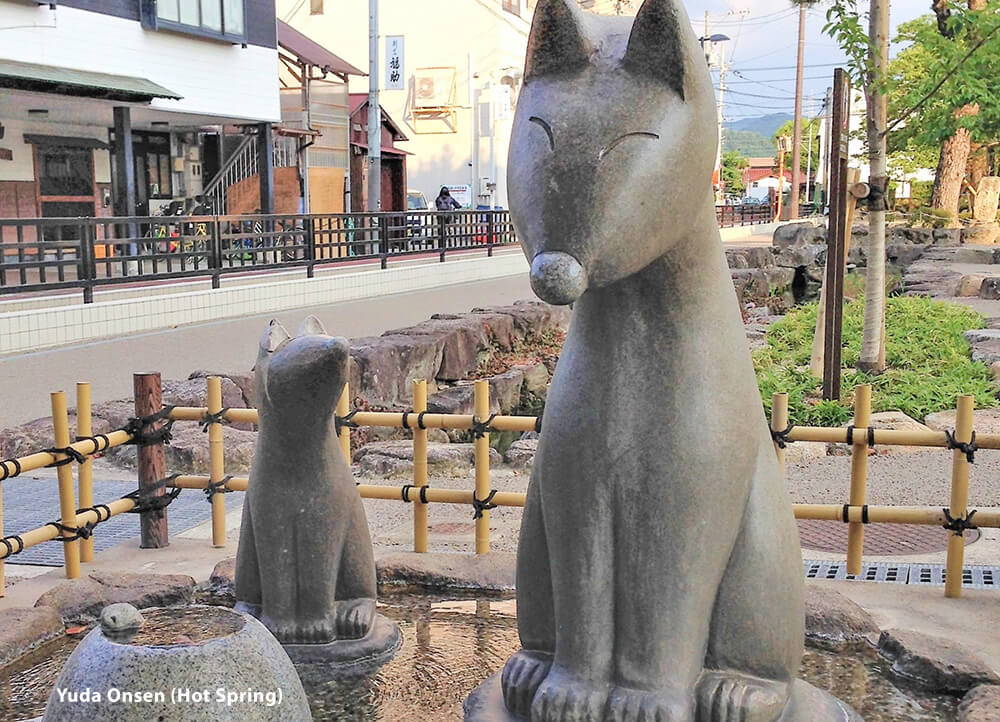 Fox statues in Yuda Onsen celebrates the legend of a white fox who discovered and healed its wound in the Yuda Hot Springs